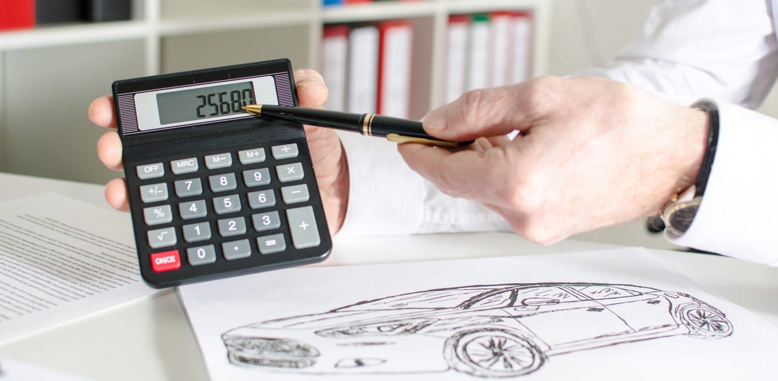 Car salesman showing the price of a car