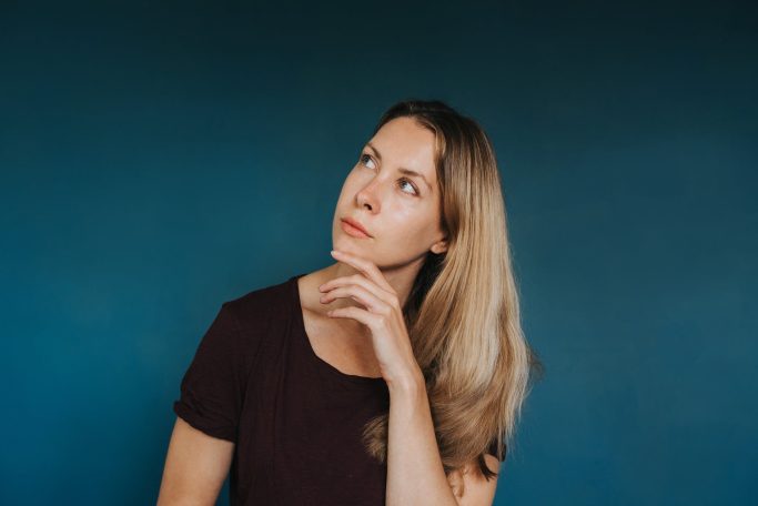 dreamy woman standing against blue background