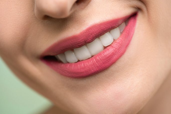 woman with red lipstick smiling