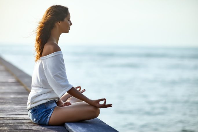 Woman meditating in Lotus Pose