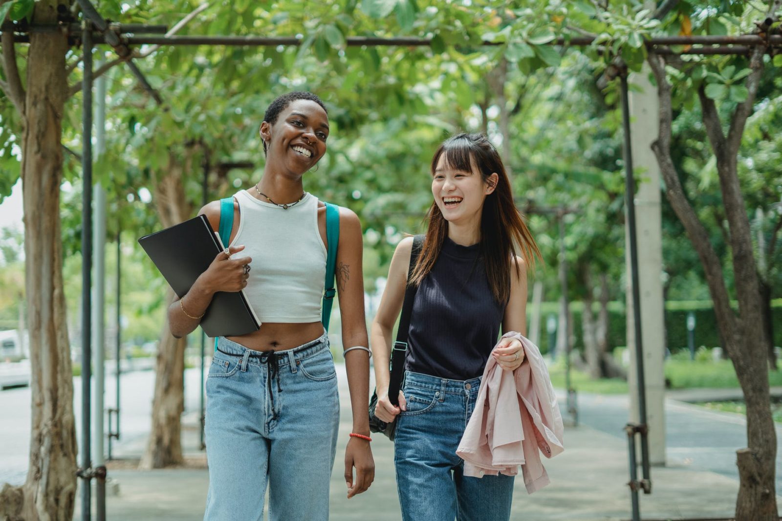 laughing multiethnic women in alley